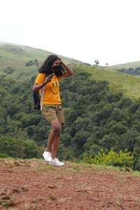 Full length of woman standing on mountain road