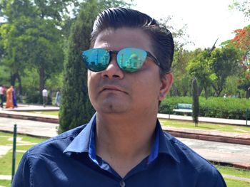 Portrait of young man wearing sunglasses in park