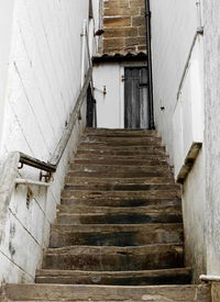 Low angle view of staircase leading towards old building