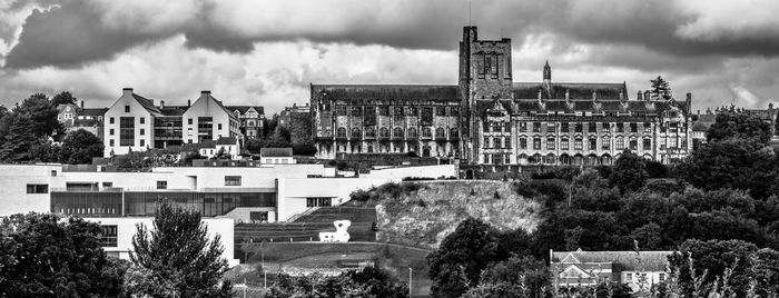 Panoramic view of buildings in town against sky