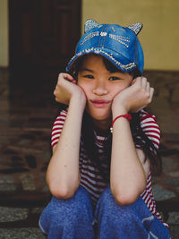 Portrait of smiling boy sitting outdoors