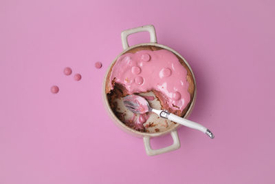 High angle view of ice cream against pink background