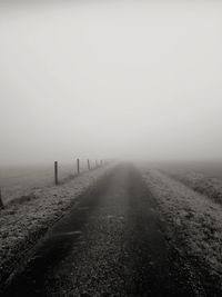 Road leading towards foggy weather