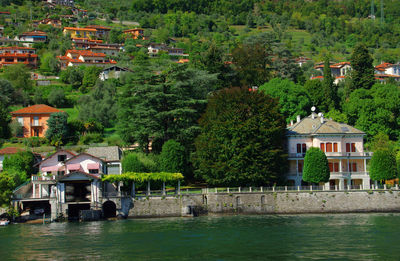 Calm lake with built structures amid plants