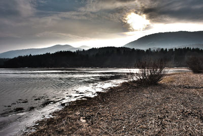 Scenic view of mountains against cloudy sky