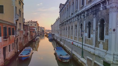 Boats in canal with buildings in background