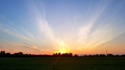 Panoramic view of field against sky during sunset