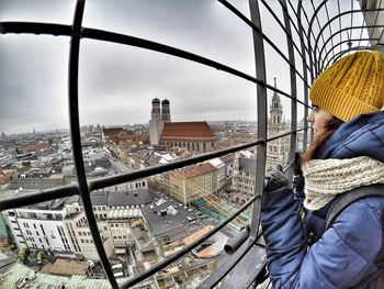 Close-up of man with window in city