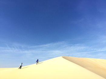 Man on snow covered landscape against sky