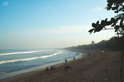 People on beach against sky