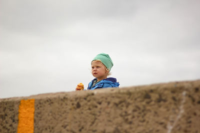 Portrait of boy wearing hat against sky