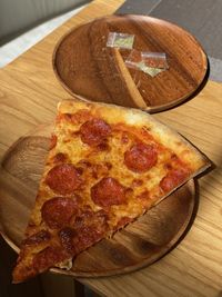 High angle view of pizza on cutting board