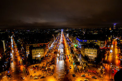 High angle view of illuminated cityscape against sky at night