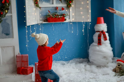 Rear view of boy in traditional clothing during winter