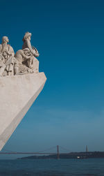 Statue of sea against blue sky