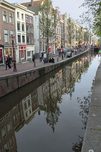 Reflection of people on puddle in city