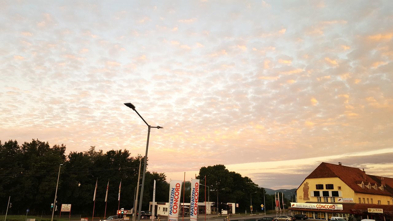 sunset, building exterior, sky, built structure, architecture, cloud - sky, car, tree, silhouette, street light, transportation, mode of transport, city, land vehicle, cloudy, house, orange color, nature, street, cloud