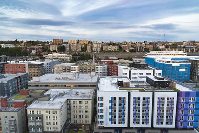 High angle view of buildings in city against sky