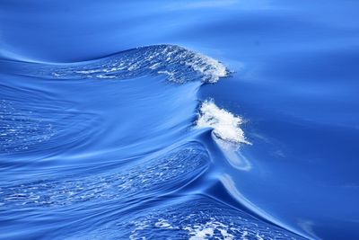 Aerial view of sea against blue sky