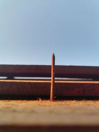 Scenic view of clear sky and rusty nail 