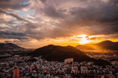 Aerial view of townscape against sky during sunset