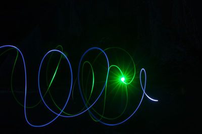 Close-up of light painting against black background