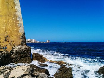 Scenic view of sea against clear blue sky