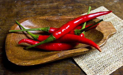 High angle view of chili peppers on cutting board