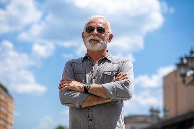 Portrait of man standing against sky
