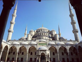 Low angle view of mosque against clear sky