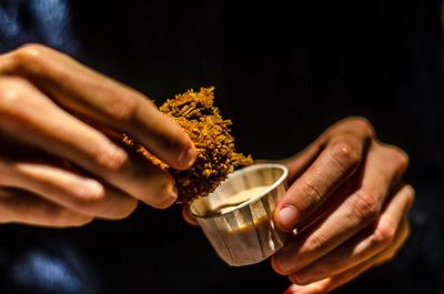 Close-up of hand holding cigarette