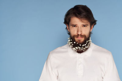 Portrait of young man against blue background