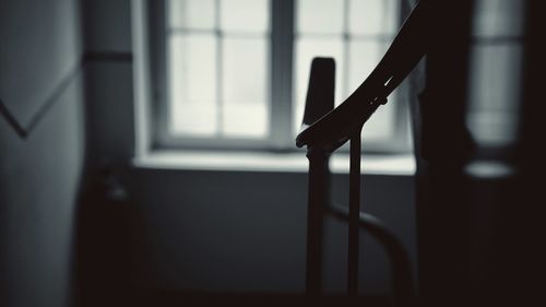 Close-up of metal railing against window at home