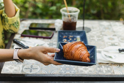 Cropped hand of woman using mobile phone