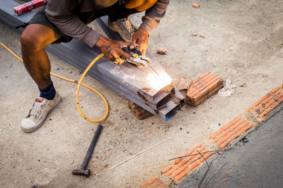 Low section of man working on wood