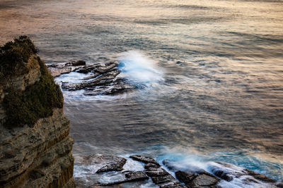 High angle view of waves breaking on rocks