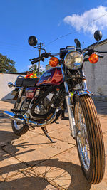 Bicycles on street against blue sky