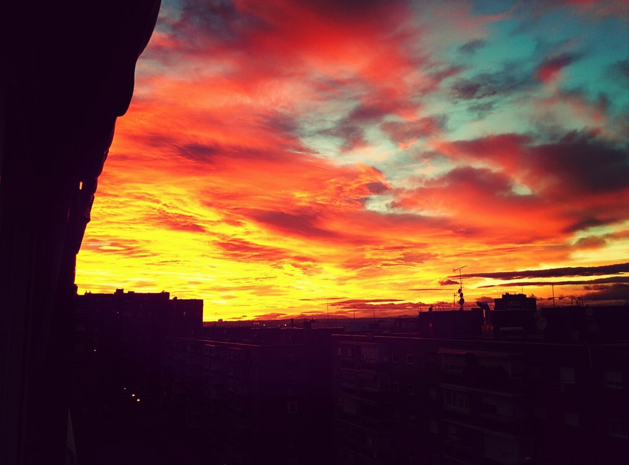 sunset, orange color, building exterior, architecture, built structure, sky, silhouette, cloud - sky, city, dramatic sky, cloudy, cloud, scenics, cityscape, moody sky, beauty in nature, building, residential building, residential structure, nature