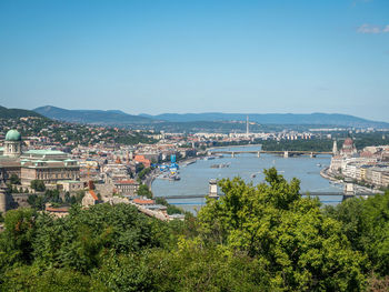 High angle view of townscape by sea against sky