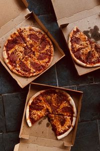 Directly above shot of pizzas in box