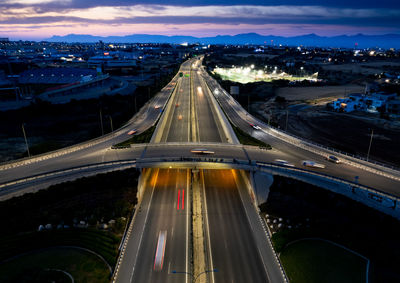 High angle view of illuminated bridge in city at night