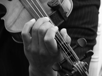 Close-up of man playing guitar