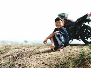 Full length of boy on field against sky