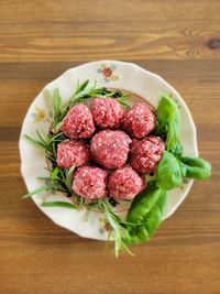 Directly above shot of raw meat balls in plate on table myranaut beef farmers.