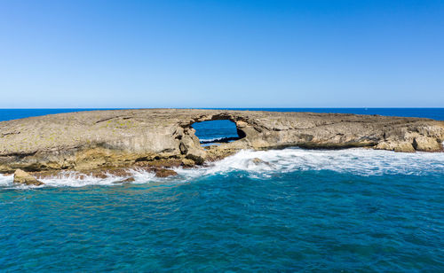 Sea arch or eroded cave in seabird sanctuary island off la'ie point on oahu, hawaii