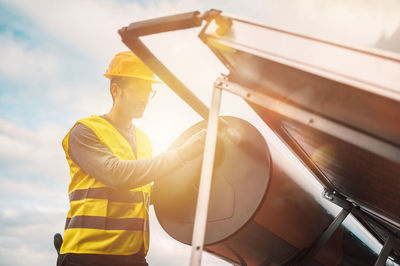 Low angle view of man holding american flag