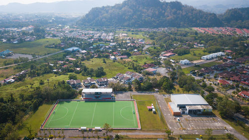 Aerial view of green carpeted field hockey stadium, kangar perlis, malaysia.