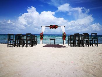 Wedding decoration at beach against sky