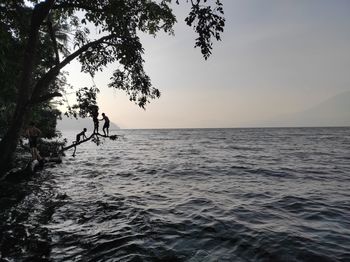 Scenic view of lake against sky at sunset