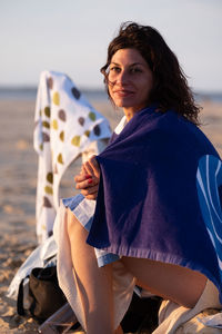 Portrait of young woman standing on beach